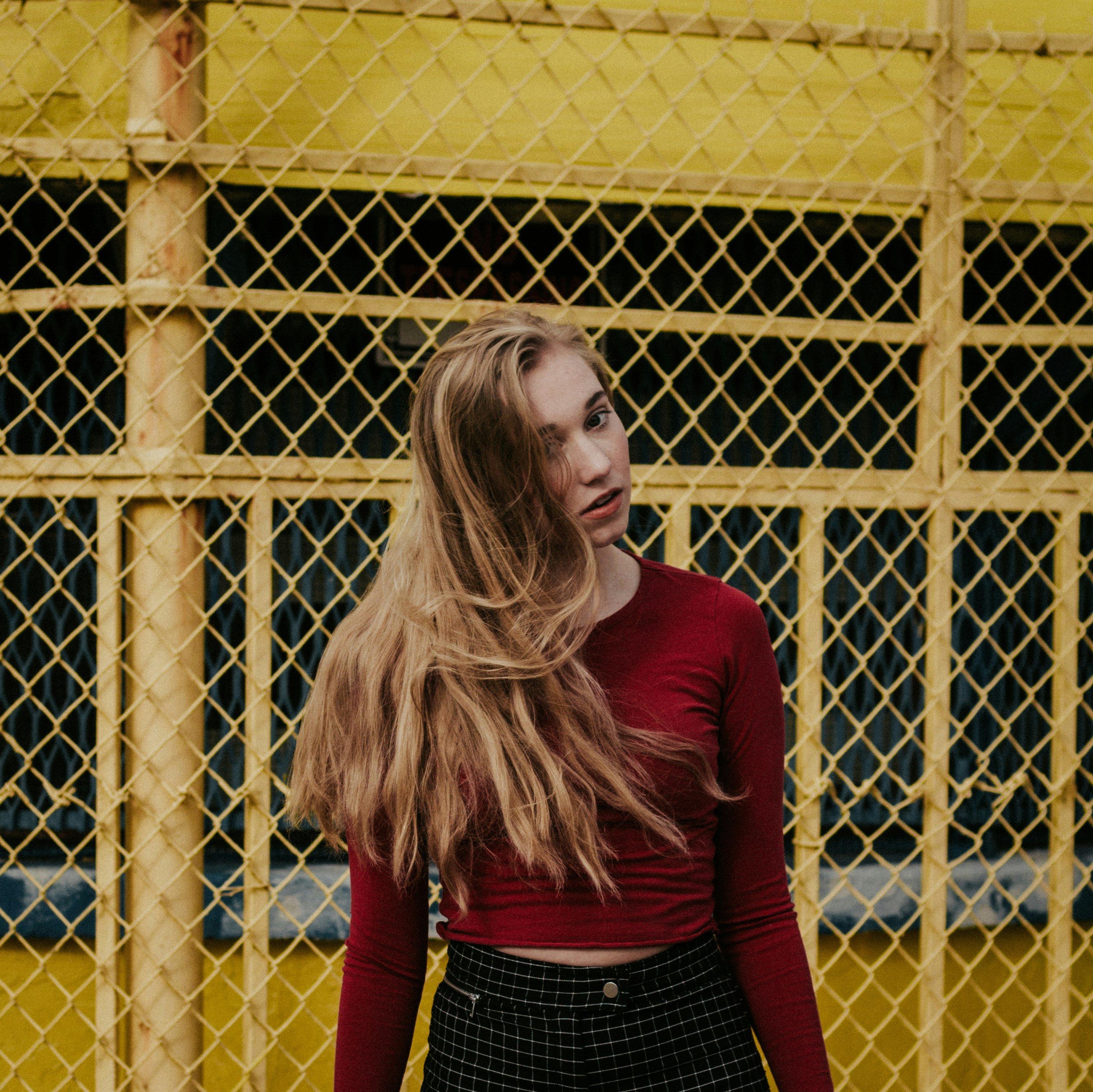 woman standing beside yellow steel frame